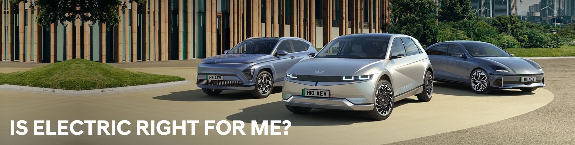 Three electric cars parked, displaying front and side views.