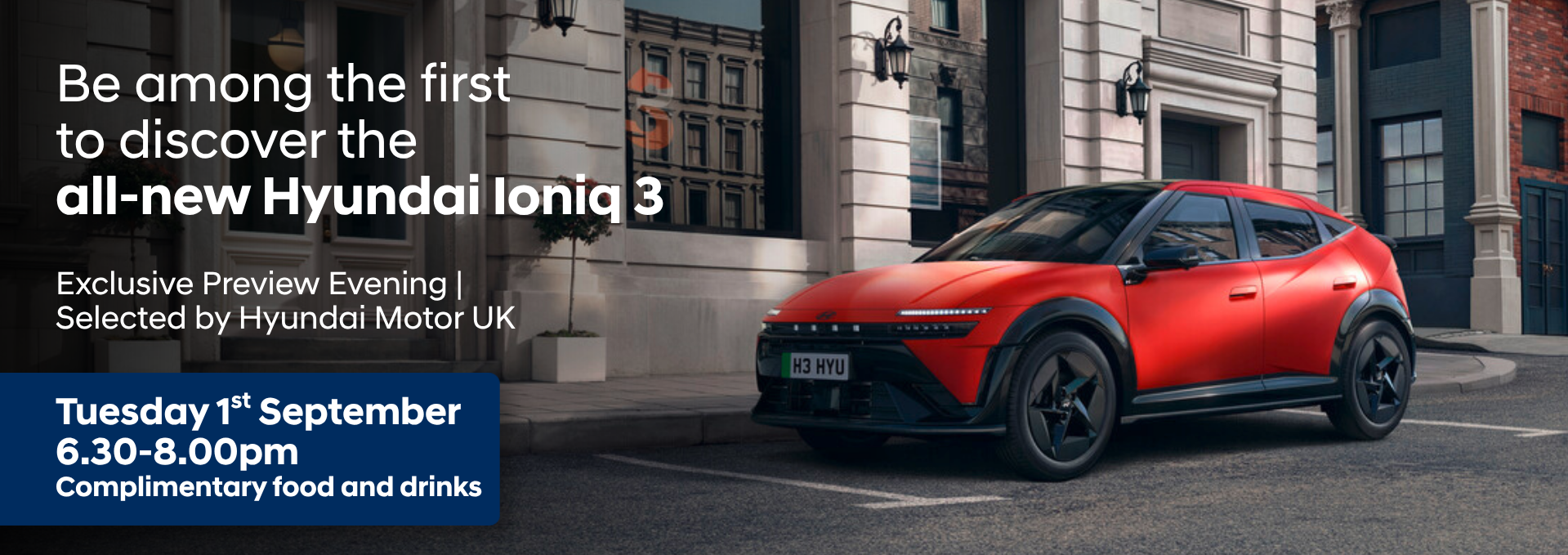 Red Hyundai Ioniq 3 parked by a building with event details alongside.