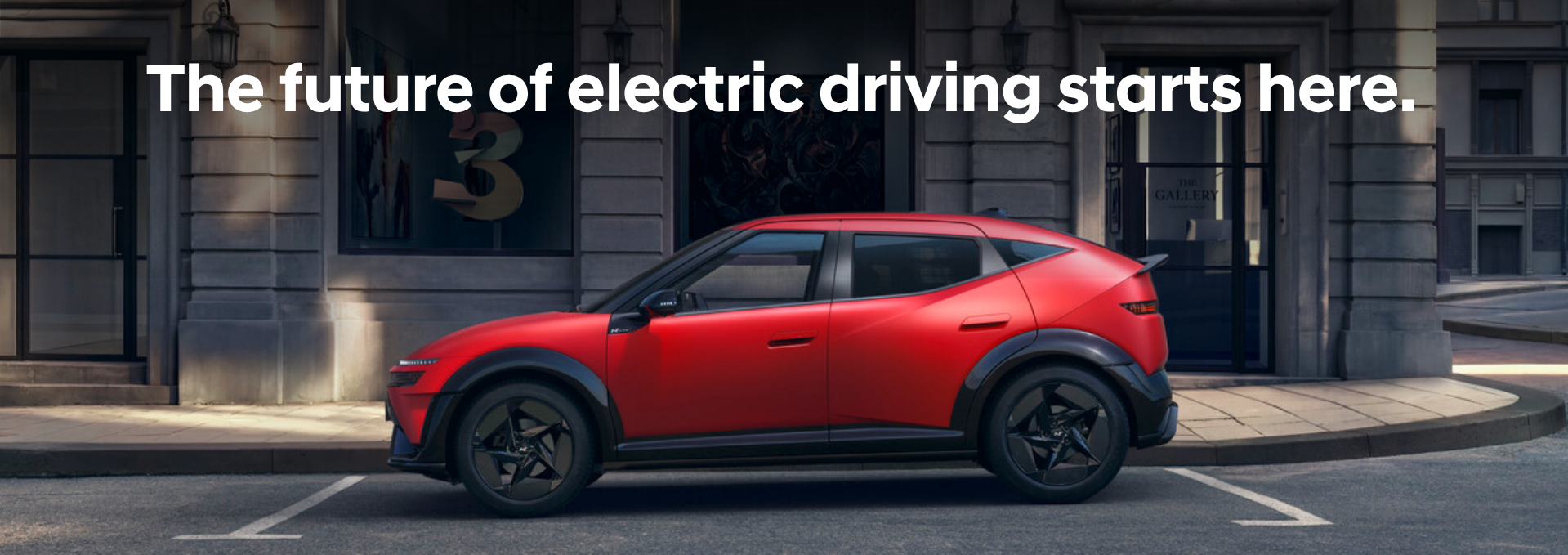 Red electric SUV parked on a city street with text above: The future of electric driving.