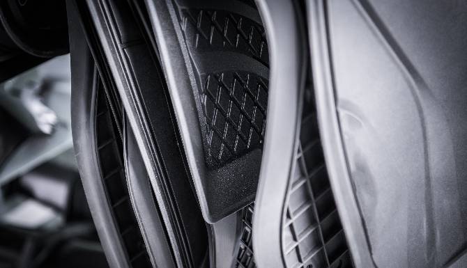 Close-up of textured car floor mats in black.